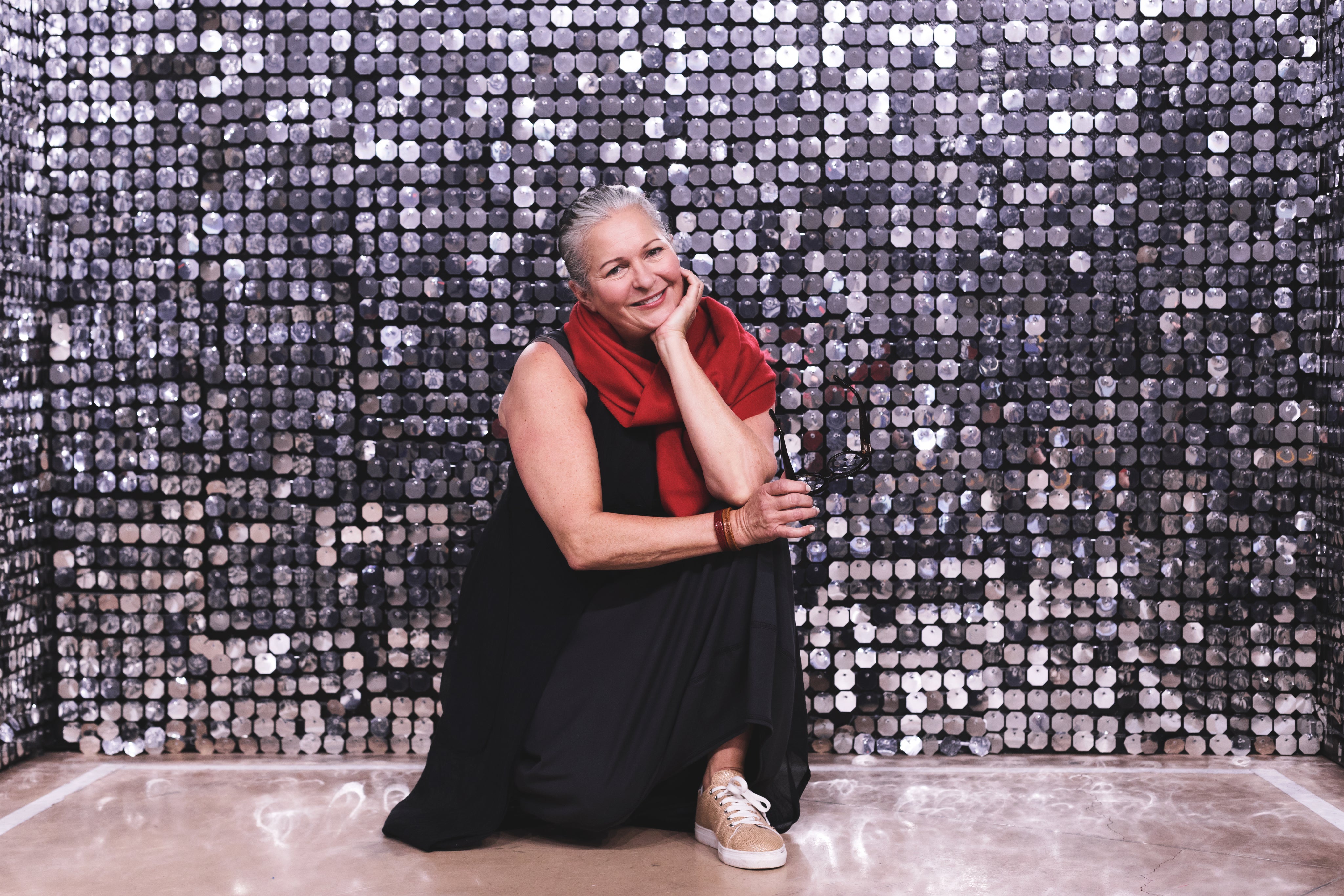 files/woman-kneels-in-front-of-silver-backdrop.jpg